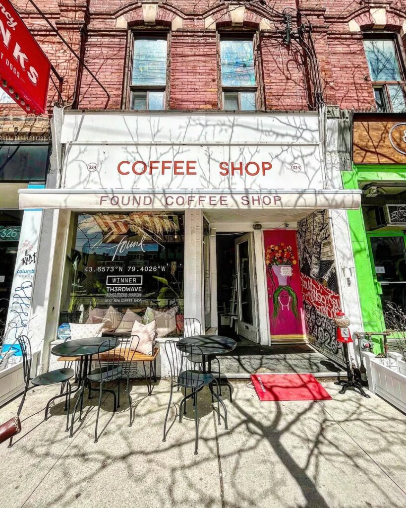 Found Coffee Toronto | Exterior shot of Found's College St location with red brick facade and outdoor seating | Homes Almanac