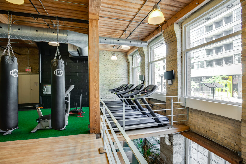 Totum Life Science | Bright and airy interior with exposed brick, treadmills, boxing area and turf | Homes Almanac