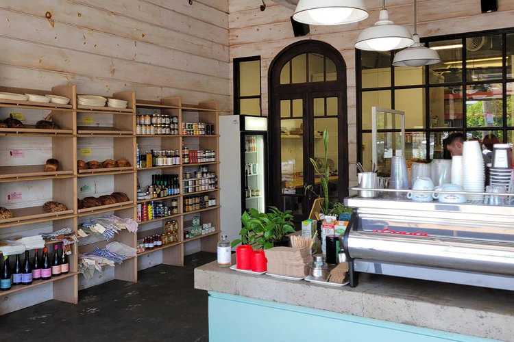 Dark Horse Espresso | Shelf lined with breads, jams and treats at Dark Horse Espresso Bar—designed for discovery and reflection | Homes Almanac