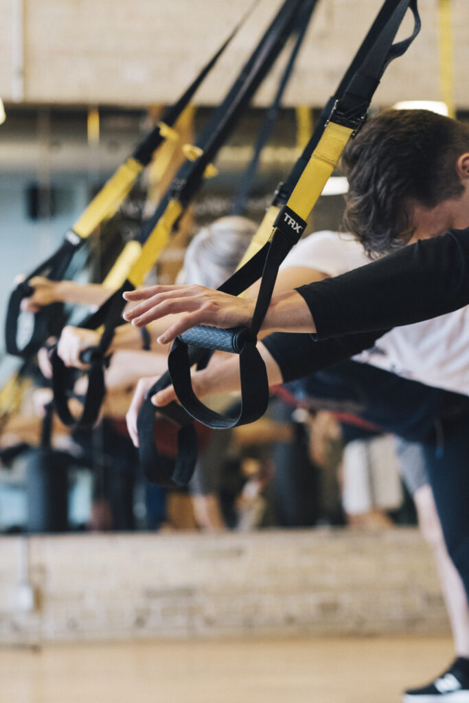 Totum Life Science Toronto | People taking a TRX class | Homes Almanac