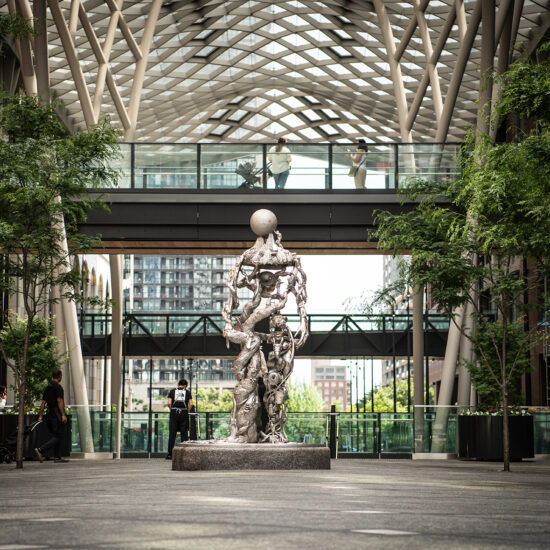The Well Toronto | An art installation at the entrance on Wellington St. surrounded by greenery | Homes Almanac