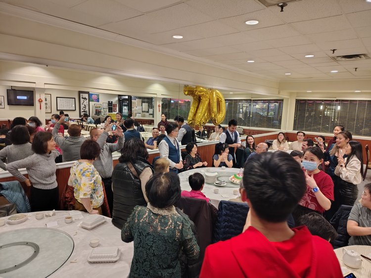 Sun Bo Kong Vancouver | A group of people celebrating with gold 70 balloons | Homes Almanac