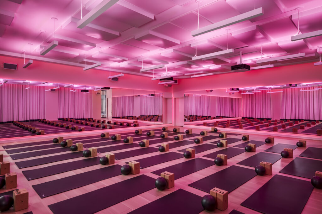 Sweat and Tonic | Yoga and Pilates room lit with pink ambient lighting | Homes Almanac