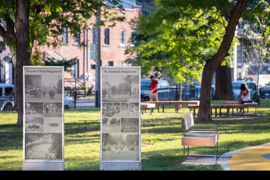Historic Downtown Toronto Park | Sunny park in background with plaques showing images of St. Andrew's Playground from 1909 | Homes Almanac