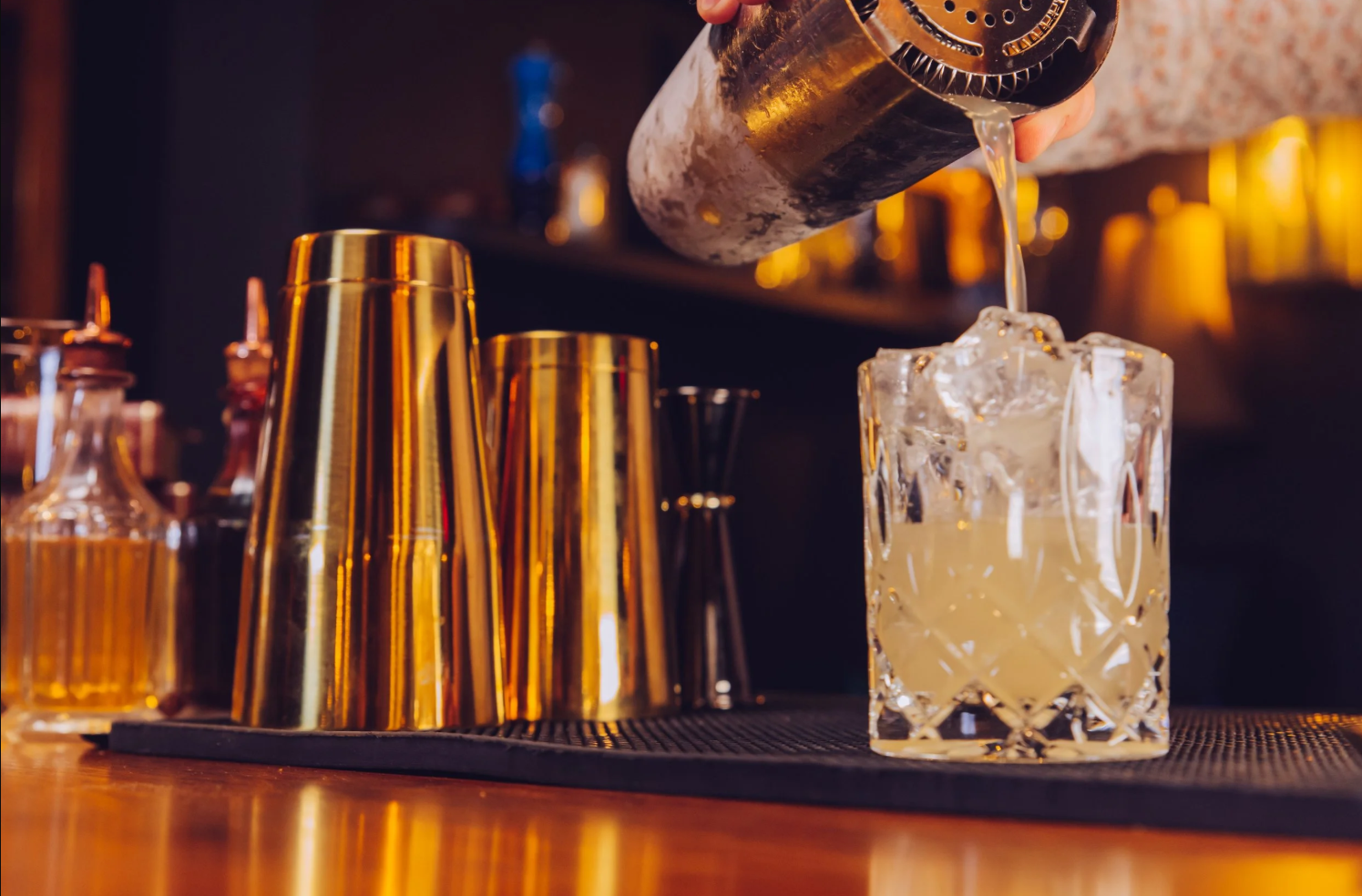 The Red Accordion Vancouver | Cocktail being poured from a shaker into a glass | Homes Almanac