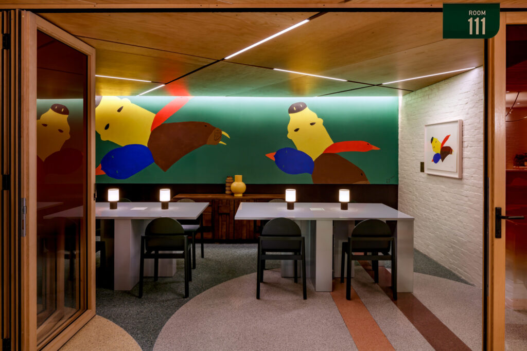 Toronto Hotel Lobbies | Bright art in primary colours on the wall with white tables and black chairs | Homes Almanac
