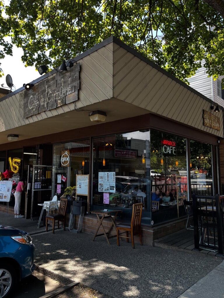 French Japanese Cafe in Marpole Vancouver | Exterior of neighbourhood restaurant with 'Café de L’Orangerie' written on a wooden sign | Homes Almanac