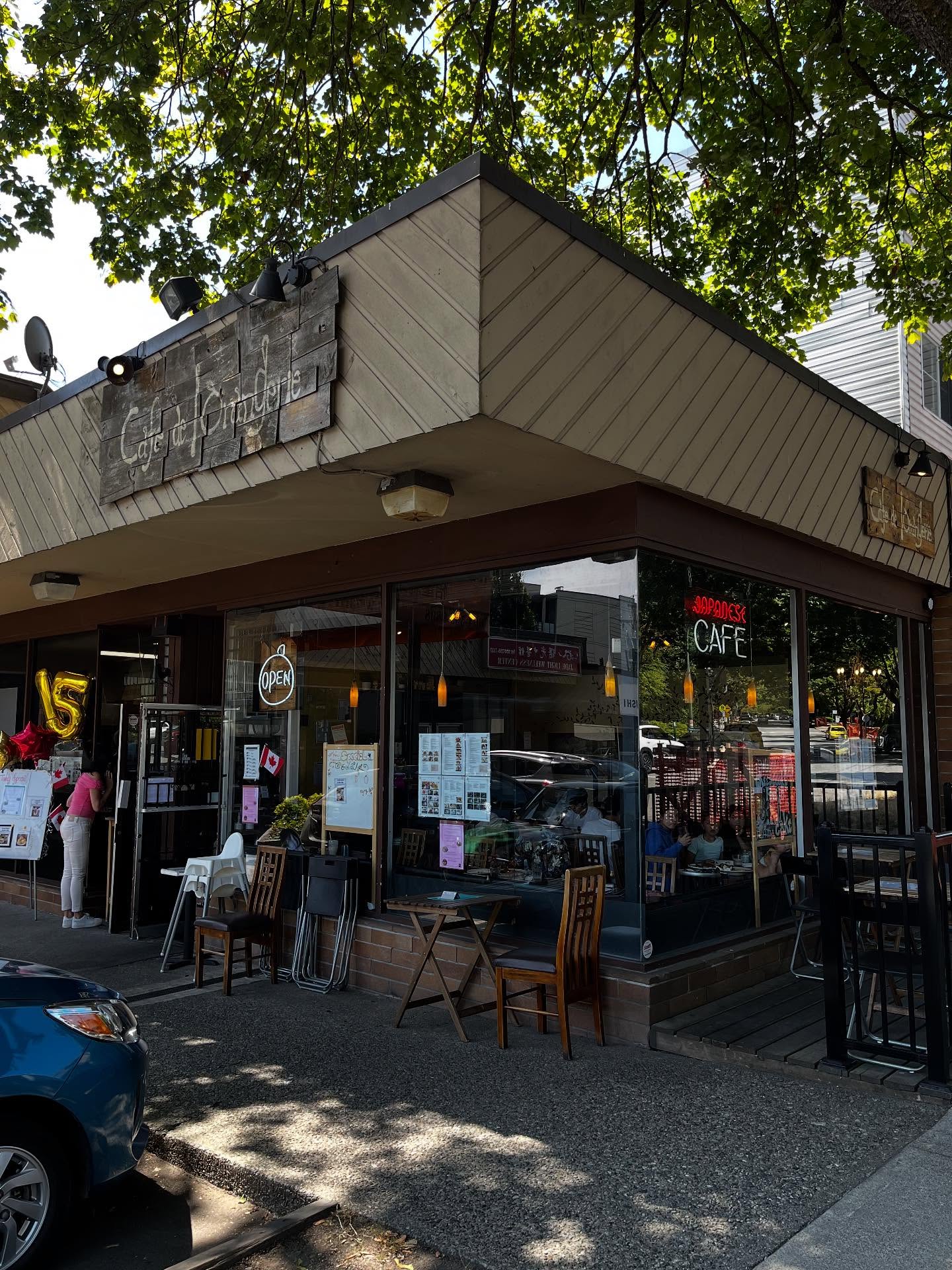 French Japanese Cafe in Marpole Vancouver | Exterior of neighbourhood restaurant with 'Café de L’Orangerie' written on a wooden sign | Homes Almanac