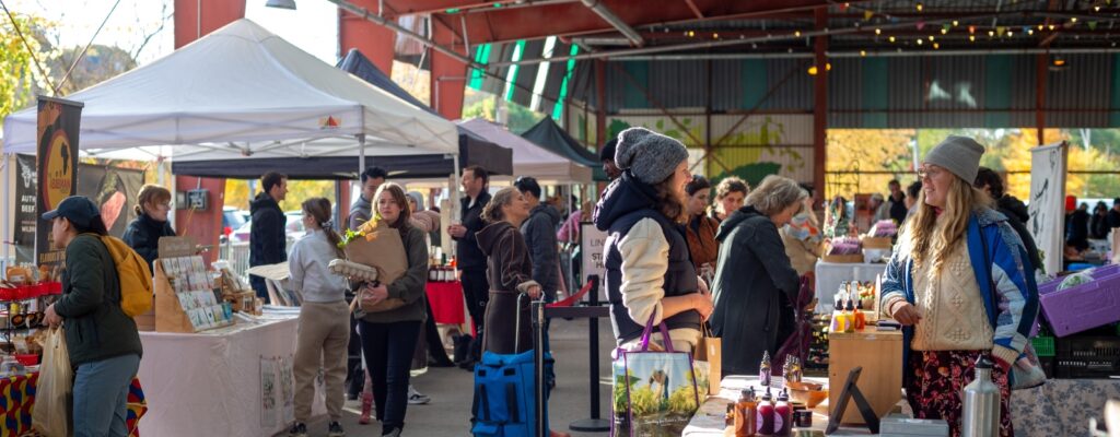 Toronto Farmers Markets | People walking and talking to vendors during the day at Evergreen Brickworks | Homes Almanac
