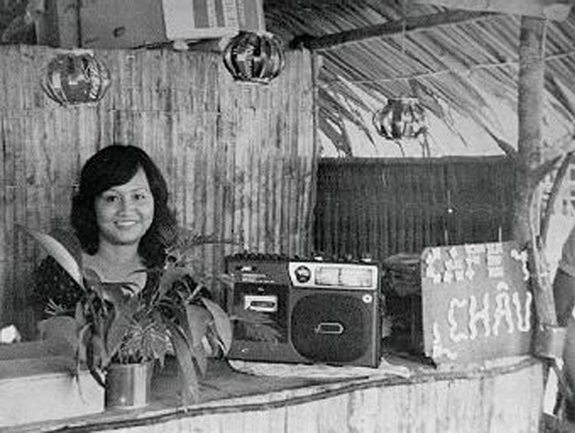 Historic photo of Chau Cafe founder's mother, taken from Saigon | Photo of woman behind stall in Saigon | Homes Almanac
