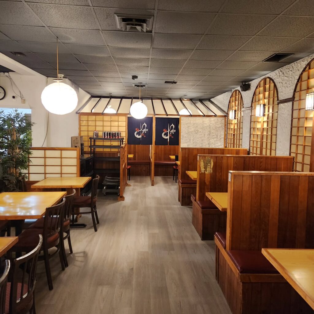 The restaurant's interior with original wood panel booths and new flooring | Korean Village in Koreatown | Homes Almanac