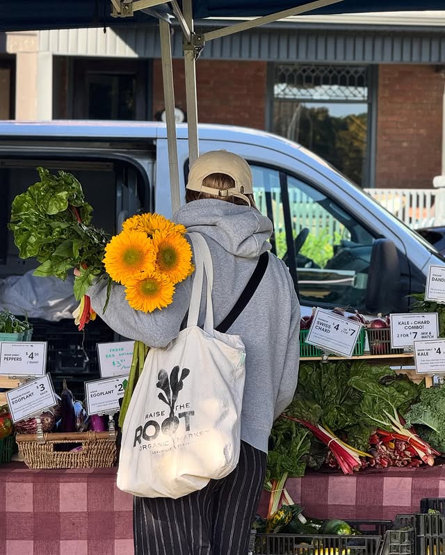 Toronto Farmers Markets | A woman with a tote bag looking over a table of fresh produce | Homes Almanac