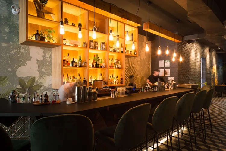 Mother cocktails toronto | Bar with shelving holding liquor and backlit | Homes Almanac
