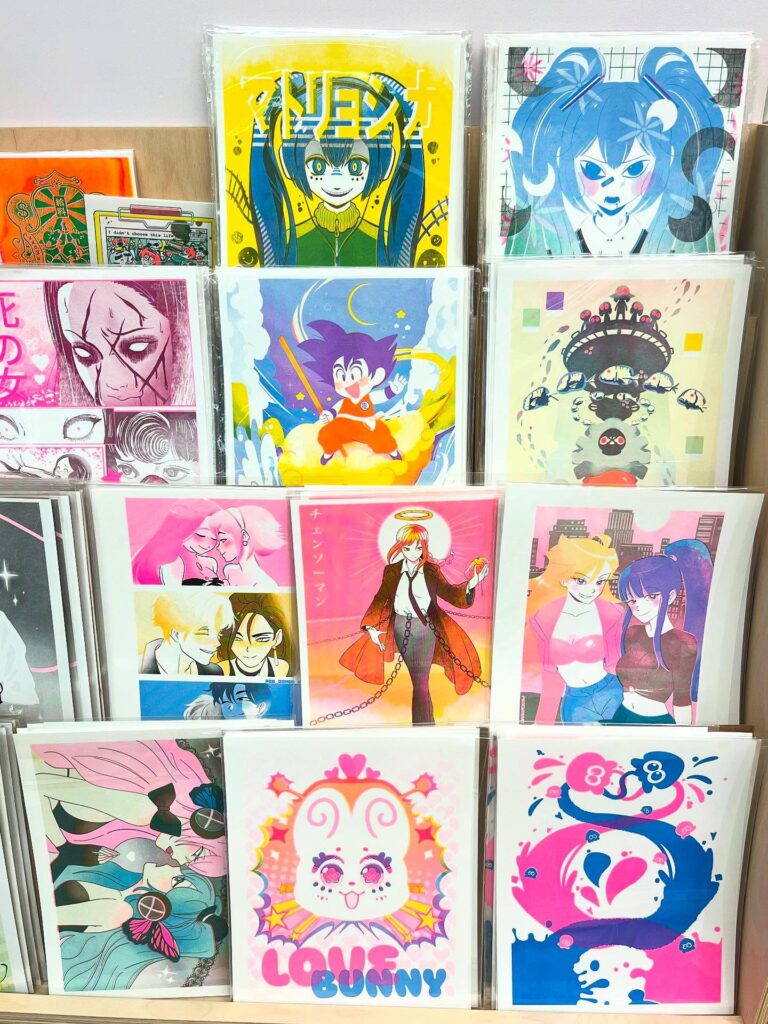 Copycat Studio Risograph Printing Richmond | Shelf with four tiers of colourful risograph prints packaged for retail | Homes Almanac 