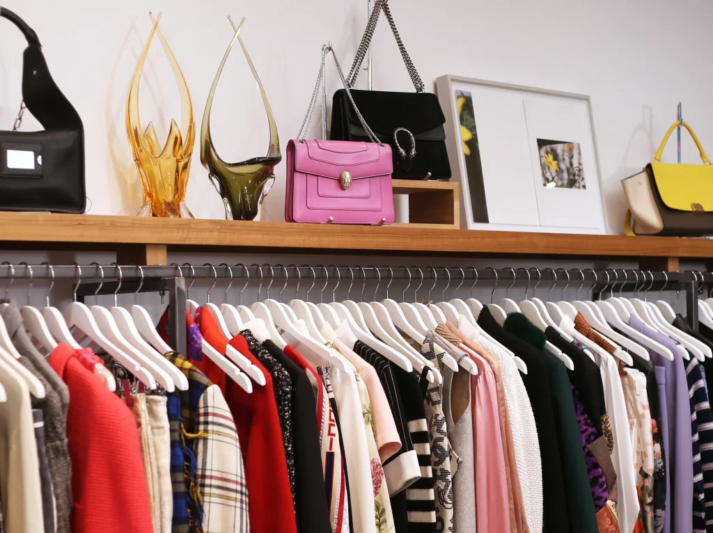 VSP Consignment | Rack and shelf with brightly coloured purses and tops | Homes Almanac
