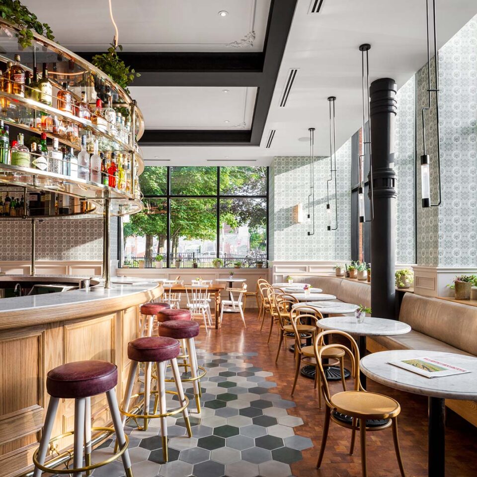 Third Place Hotels Toronto | A brightly lit cafe and bar with oak wood finishings, a bar & seating to the left and cafe seating to the right | Homes Almanac