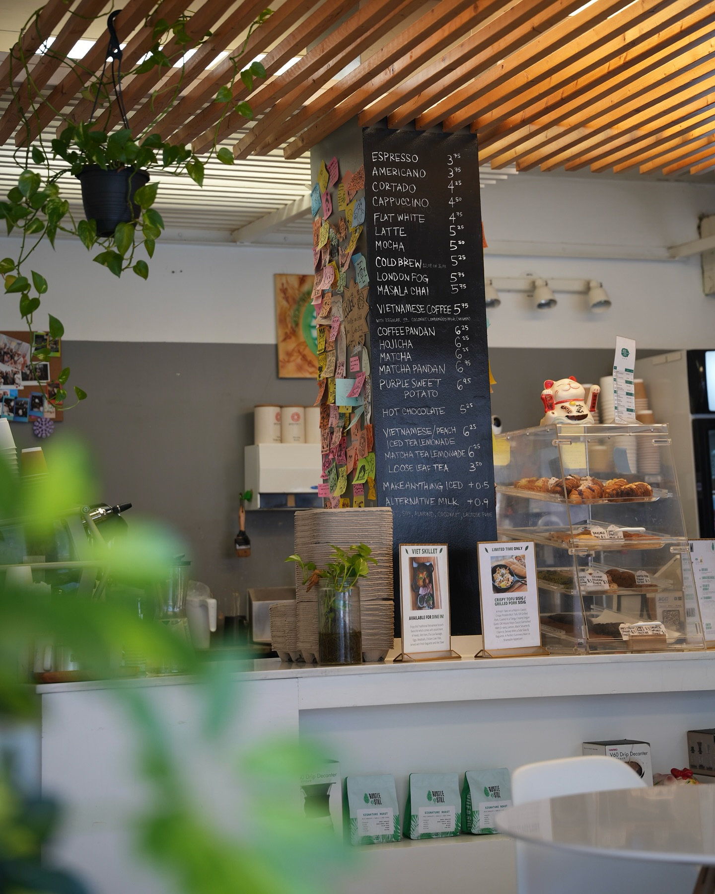 Rustle & Still Café | Leafy open coffee shop with a chalkboard menu behind the bar | Homes Almanac