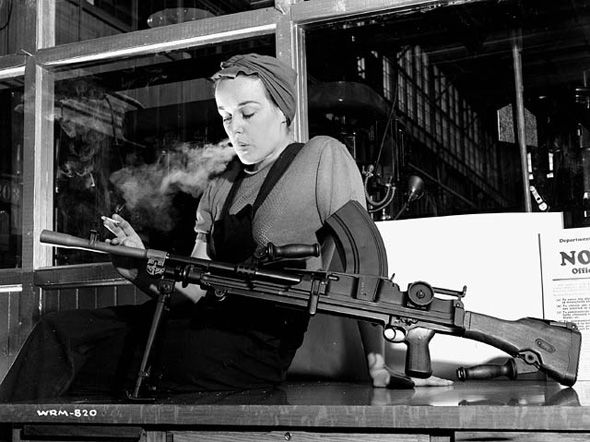 History of Liberty Village | Black and white image of Veronica Foster Bren girl smoking a cigarette looking over a gun | Homes Almanac