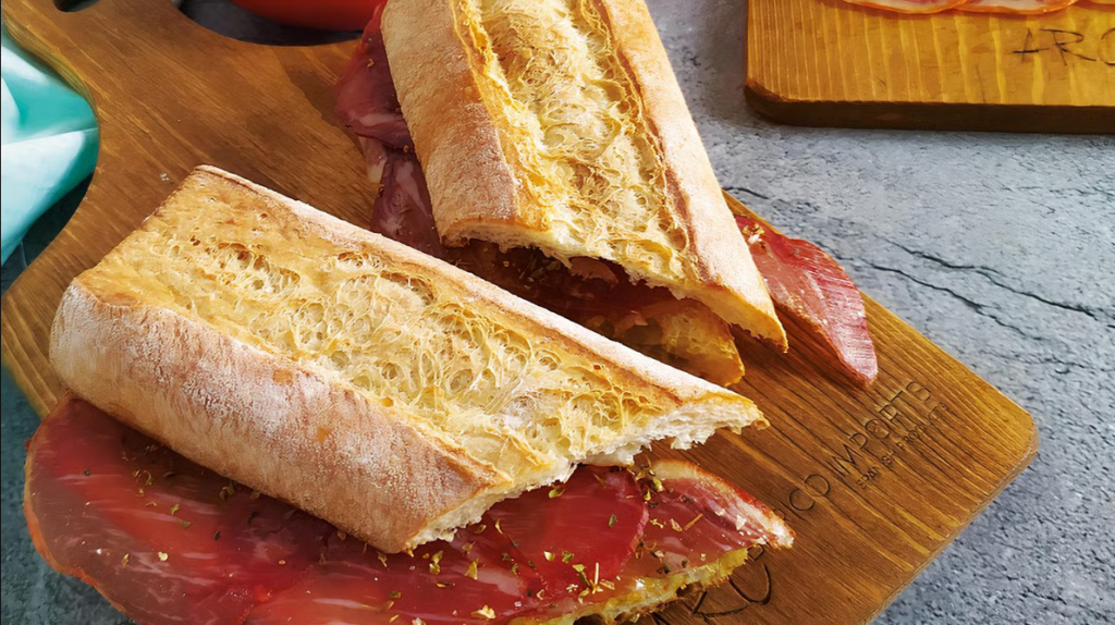 Jamoneria by Arc Imports | Two jamon bocadillos on a wooden cutting board | Homes Almanac