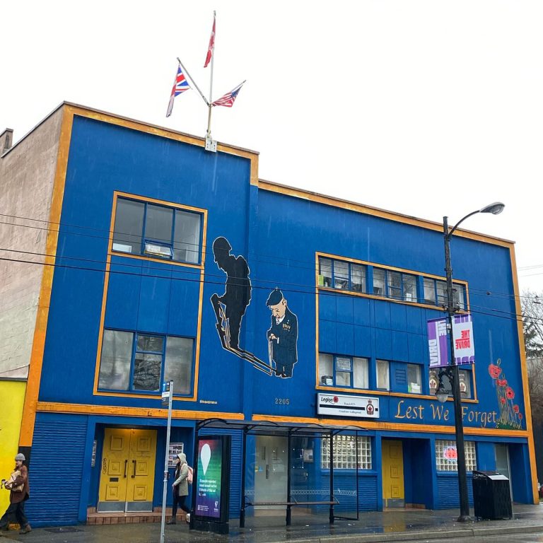 A cobalt blue 2 storey building with yellow trim | The Legion Commercial Drive | Homes Almanac