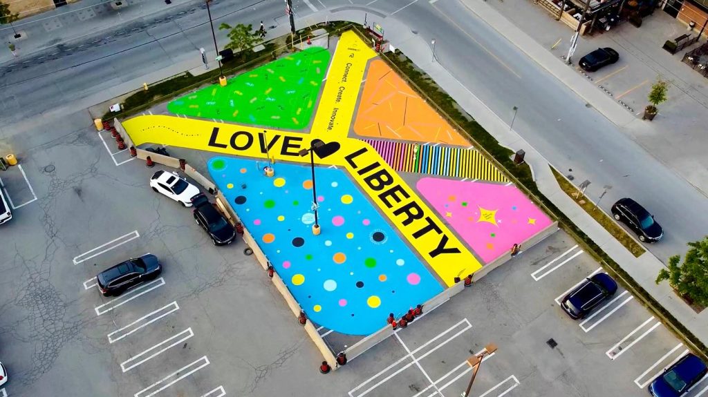 History of Liberty Village | Aerial shot of the Love Liberty mural with bright yellow, blue, pink and orange | Homes Almanac