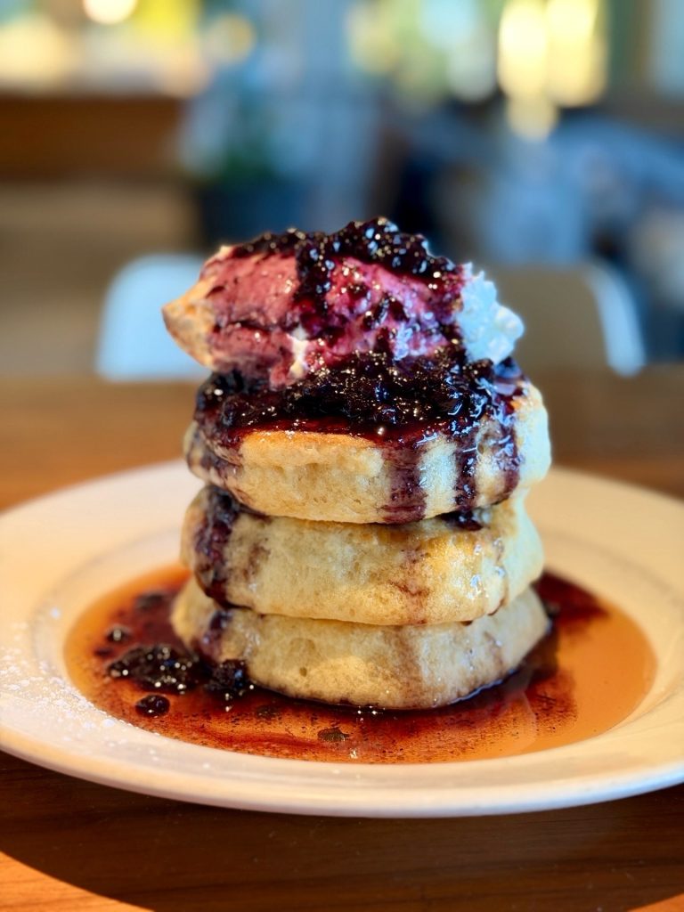 History of Liberty Village | A stack of thick pancakes with blueberry sauce and whipped cream | Homes Almanac