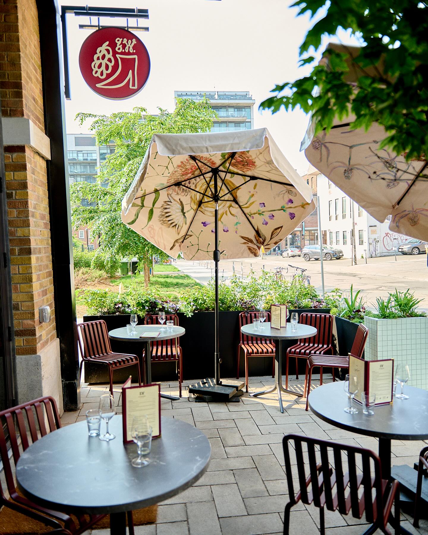 Grape Witches at Waterworks | A patio on a sunny day with white sun umbrellas and black patio furniture | Homes Almanac