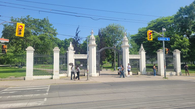 bellwoods blueprint | White gates at the entrance of Trinity Bellwoods Park on a sunny day | Homes Almanac