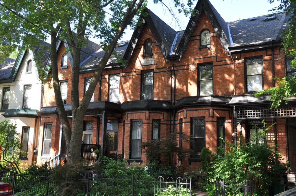 Bellwoods Blueprint | A red brick Bay and Gable Victorian home on a tree-lined street | Homes Almanac
