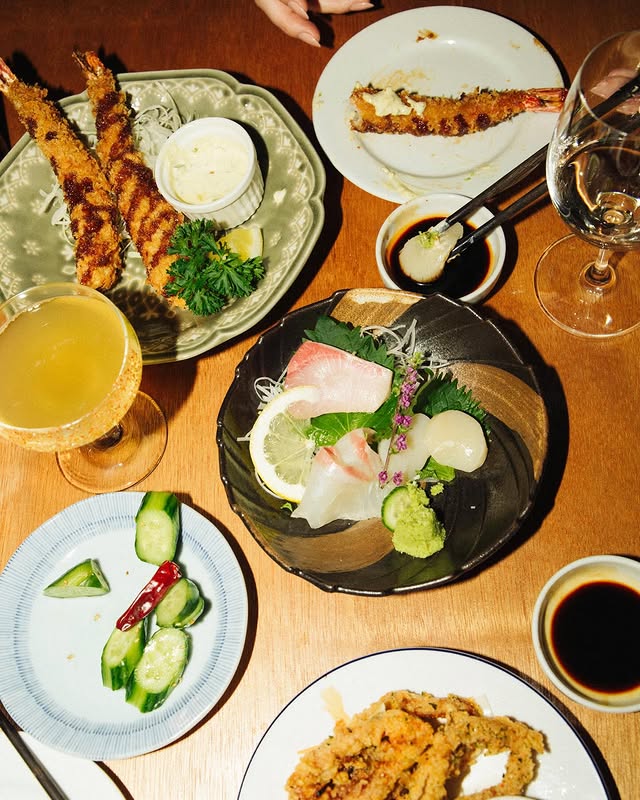 japanese izakaya toronto | Overhead shot of an array of modern japanese foods on a wood table | Homes Almanac