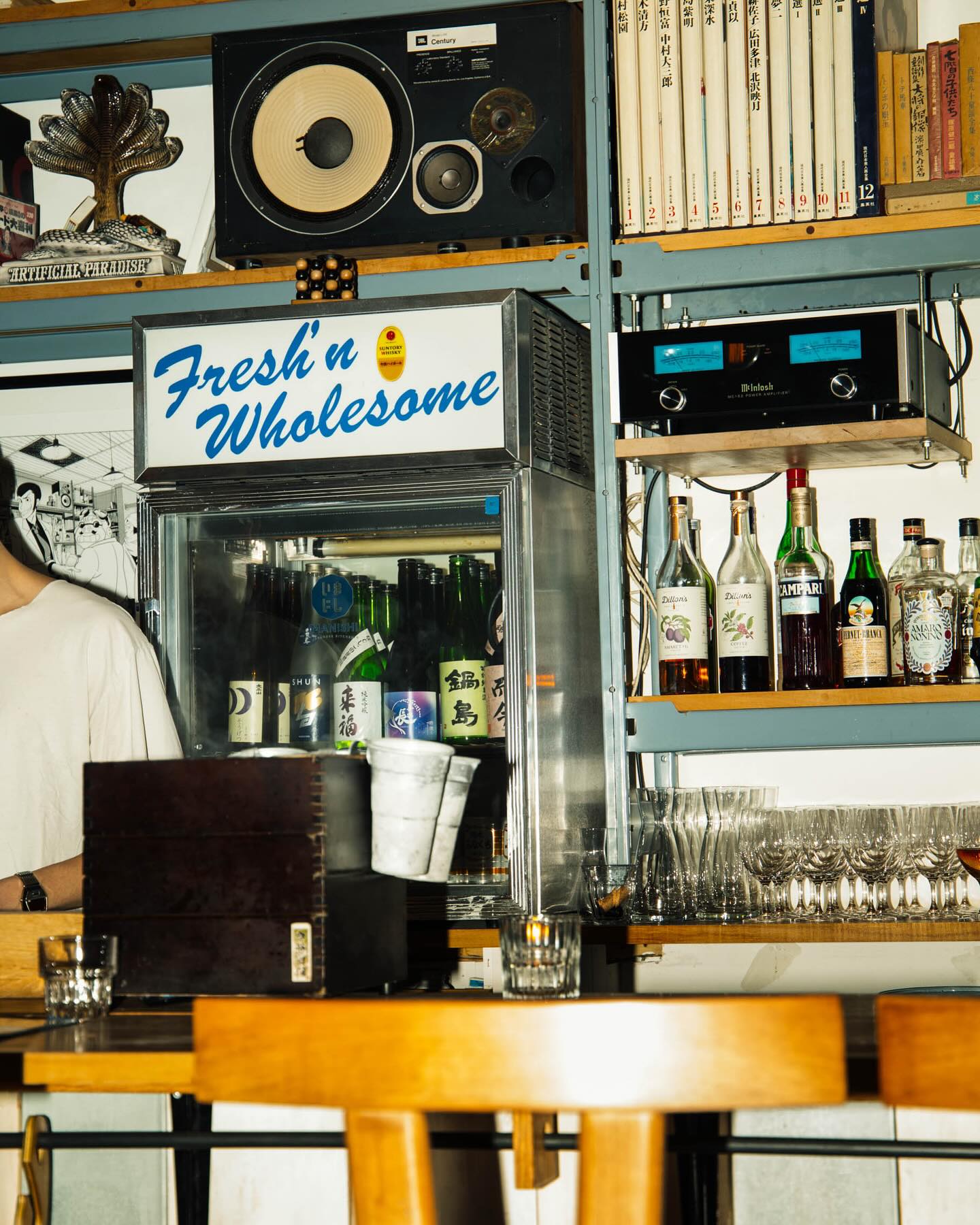 Japanese izakaya toronto | Mcintosh tube amplifier sits above a bar lined with bottles and next to a fridge that says "Fresh'n Wholesome" on the top | Homes Almanac