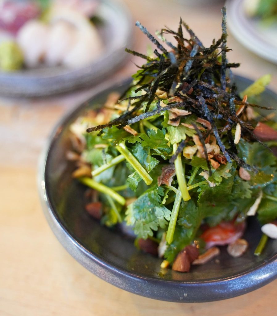 Japanese izakaya toronto | Imanishi's prawn cilantro salad with green cilantro and nori in a dark blue bowl | Homes Almanac