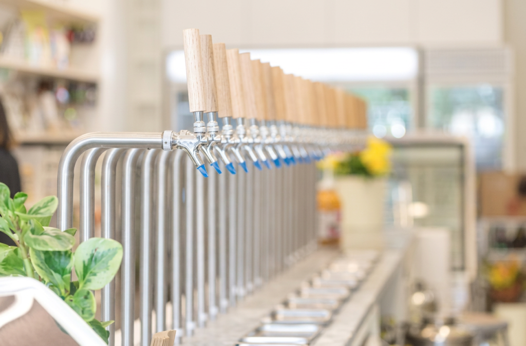 Vancouver Conscious Consumer Culture | A row of metal liquid dispensers on a marble counter top | Homes Almanac