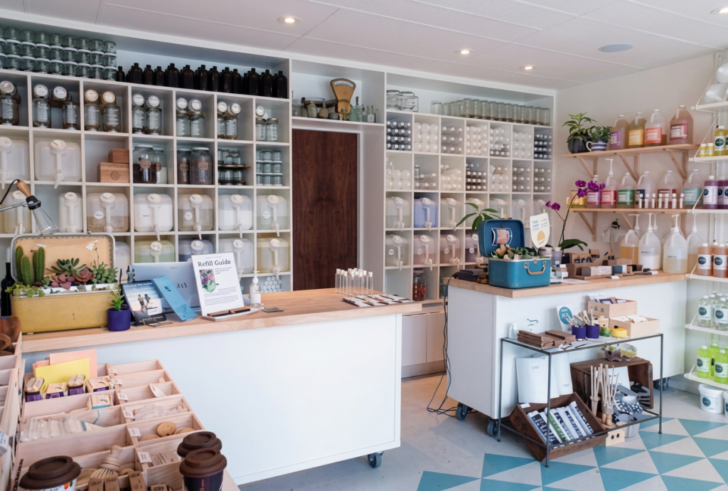 Vancouver Conscious Consumer Culture | A retail shop filled with eco-friendly refills in bottles behind a counter top | Homes Almanac